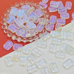 Macro view of iridescent 13x18mm rectangular glass flower beads with aurora finish