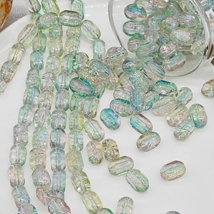 Macro shot of 6x10mm iridescent mint and pink rectangle glass beads for DIY jewelry
