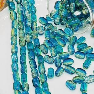 Macro detail of 6x10mm peacock blue rectangular glass beads with silver foil interior