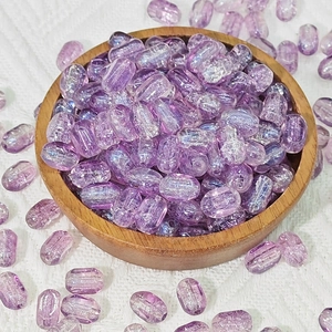 Close-up of 6x10mm purple rectangle glass beads with vertical stripes on wooden tray