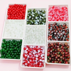 Close-up of assorted 8mm glass crackle and smooth beads in a white grid organizer tray