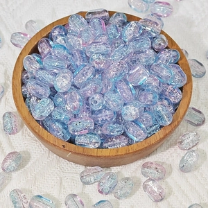 Macro detail of 6x10mm rectangular crackle glass beads with blue purple aurora finish