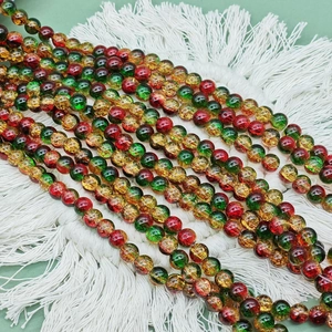 Macro shot of red green and gold cracked glass beads for Christmas DIY jewelry making