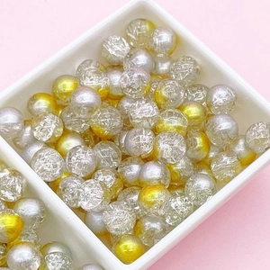 Macro view of gold and silver cracked glass beads for DIY jewelry making and crafts