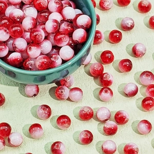 Macro shot of red and pink gradient crackle glass beads for DIY jewelry making