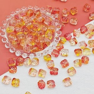 Macro view of red-orange gradient glass beads with textured surface for DIY jewelry
