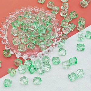 Macro detail of light green glazed beads with gold foil foil inside for DIY jewelry