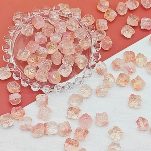 Macro shot of pink and yellow gradient lion dance beads with holes for DIY jewelry