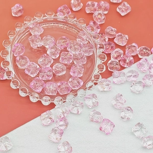 Macro detail of pink gradient DIY beads with gold foil flakes for handmade jewelry making