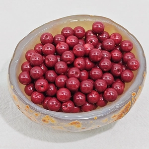 Macro shot of 4-8mm deep red synthetic chalcedony beads for DIY jewelry making
