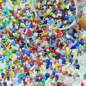 Macro shot of colorful mixed glass beads spilling from a bottle for DIY jewelry crafts