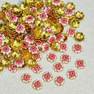 Detail of plum blossom enamel flower beads in gold finish for DIY jewelry making