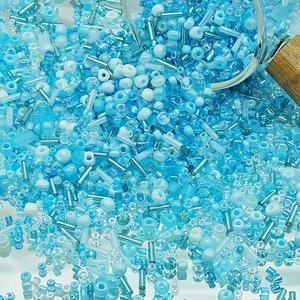 Close-up of mixed blue glass seed beads and tube beads for DIY jewelry making