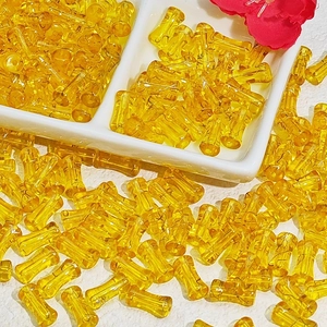 Detailed view of yellow transparent bamboo-style glass beads for DIY jewelry making