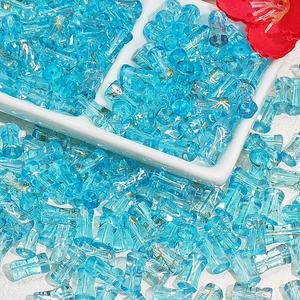 Macro shot of light blue glass beads with gold thread texture for jewelry making
