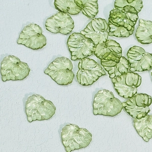Macro detail of leaf-shaped acrylic beads with veins for DIY jewelry making
