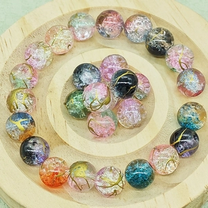 Dettaglio macro di perle in vetro cracklé multicolore con trama dorata per gioielli fai-da-te