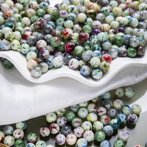 Vue macro de perles rondes en verre peintes à l'encre pour bijoux faits main DIY
