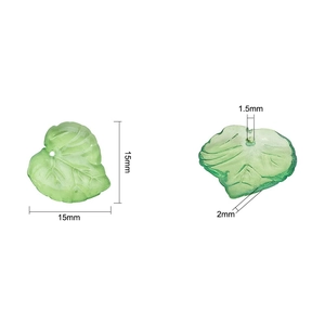 Macro detail of 15mm frosted green acrylic leaf beads with clear vein textures for DIY crafts
