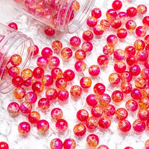 Macro detail of 10mm pink and orange crackle glass beads with silver wire silk for DIY