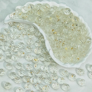 Macro detail of 10mm faceted clear glass beads with gold foil for DIY jewelry making