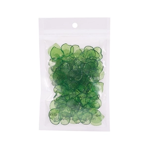 Close-up of translucent green acrylic leaf beads in a transparent pouch for DIY jewelry making