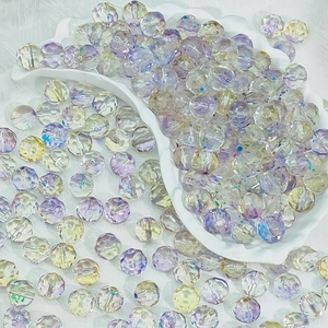 Detailed view of 10mm faceted transparent glass beads with AB rainbow effect for DIY crafts