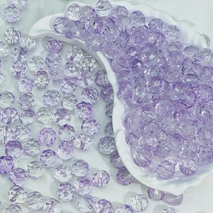 Macro detail of 10mm light purple multifaceted transparent glass beads for DIY jewelry