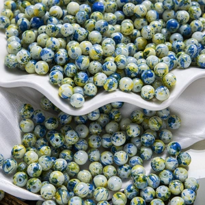 Macro de perles en céramique avec éclaboussures d'encre bleu et jaune pour bijoux DIY