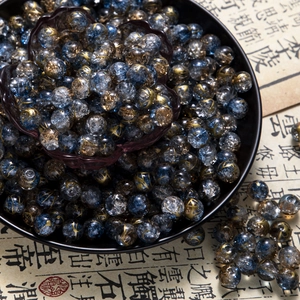 Macro detail of 10mm blue and gold crackle glass beads for DIY jewelry making