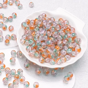 Macro shot of 10mm colorful cracked glass beads for DIY jewelry making in a shell tray