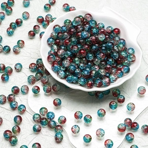 Detailed view of 10mm colorful crackle glass beads in a white decorative bowl for DIY jewelry