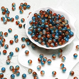 Detailed close-up of 10mm orange and blue crackle glass beads for DIY jewelry making