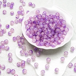 Macro shot of 10mm purple and pink crackle glass beads for DIY jewelry making