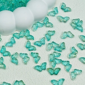 Macro detail of translucent butterfly charms with a gradient pearlescent finish