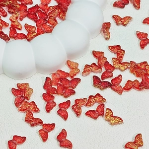 Translucent red glass butterfly beads with gold glitter detail for DIY hair accessories