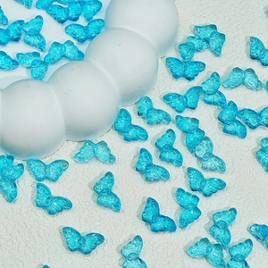 Macro shot of translucent sky blue butterfly beads for DIY jewelry and hair accessories