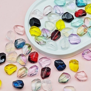 Colorful faceted glass beads for DIY jewelry making displayed on a white tray