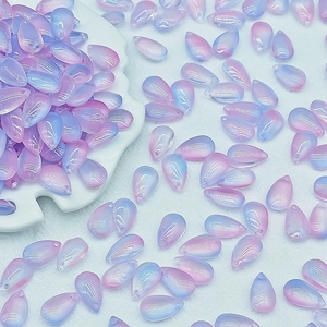 Macro detail of 8x14mm waterdrop beads with pink and blue gradient for DIY jewelry