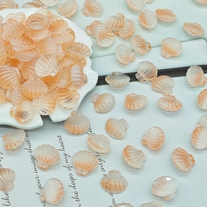 Macro view of peach scallop beads with pearlescent glaze for DIY jewelry making