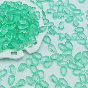 Macro view of 8x14mm mint green teardrop glass beads with precise drill holes for DIY