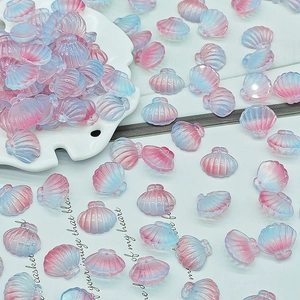 Macro detail of gradient pink and blue shell beads for DIY jewelry making with pearl luster
