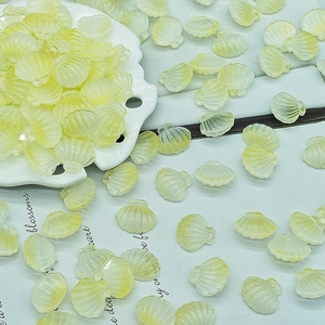 Macro detail of translucent pale yellow scallop shell beads for DIY jewelry making