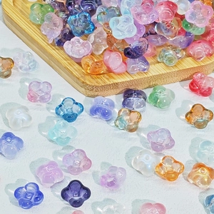 Macro shot of 10mm colorful translucent clover-shaped glass beads for DIY jewelry making