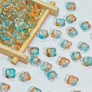 Macro detail of 10mm blue and orange gradient glass flower beads for DIY jewelry making