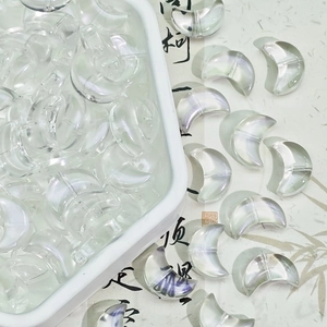 Close-up of iridescent crescent moon glass beads for DIY necklaces and jewelry making