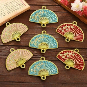 Macro shot of three-color enamel plum blossom fan charms for DIY jewelry accessories
