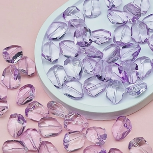Close-up of irregular light purple glass beads for DIY jewelry and necklace making