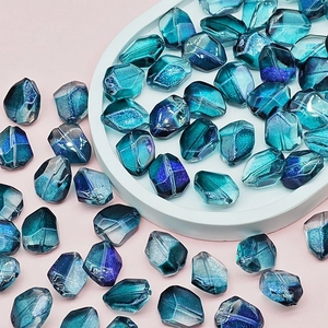 Close-up of faceted iridescent blue and purple gradient glass beads for DIY jewelry