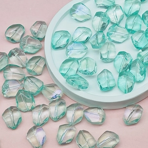 Close-up of iridescent mint green faceted glass beads for DIY jewelry making and crafts
